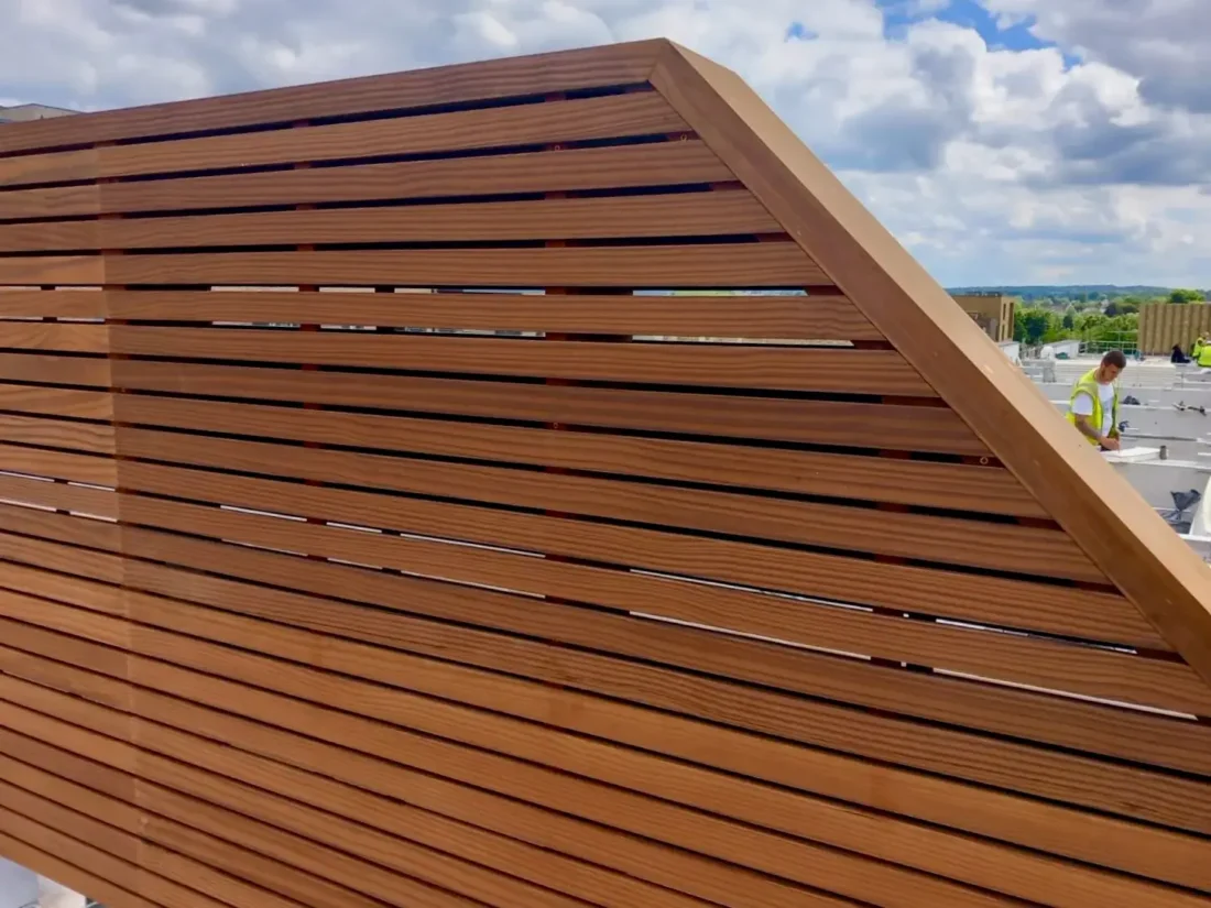 Bespoke slatted panels dividing roof terraces, in Thermally Treated Timber