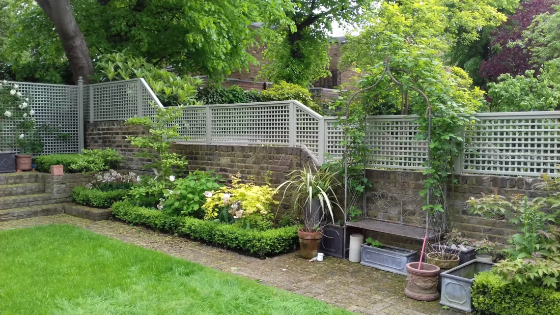 Painted Square Trellis Panels fitted atop a wall using Studded Fence Posts