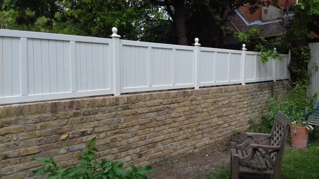 Heavy Duty Solid Panels painted Orford Cream installed atop a wall using Studded Fence Posts