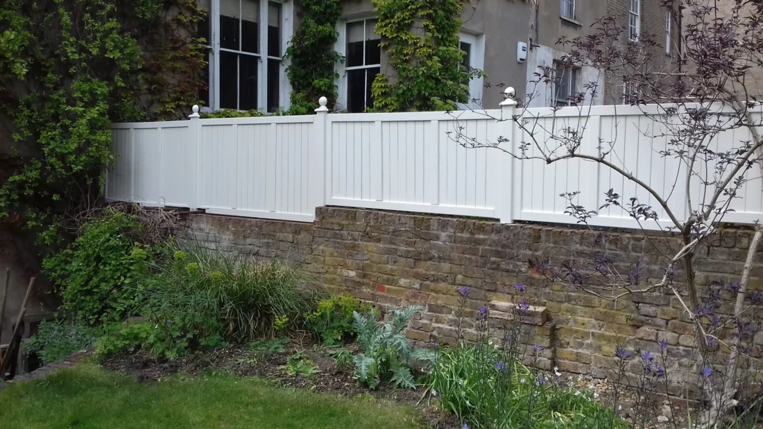 Heavy Duty Solid Panels painted Orford Cream installed atop a wall using Studded Posts