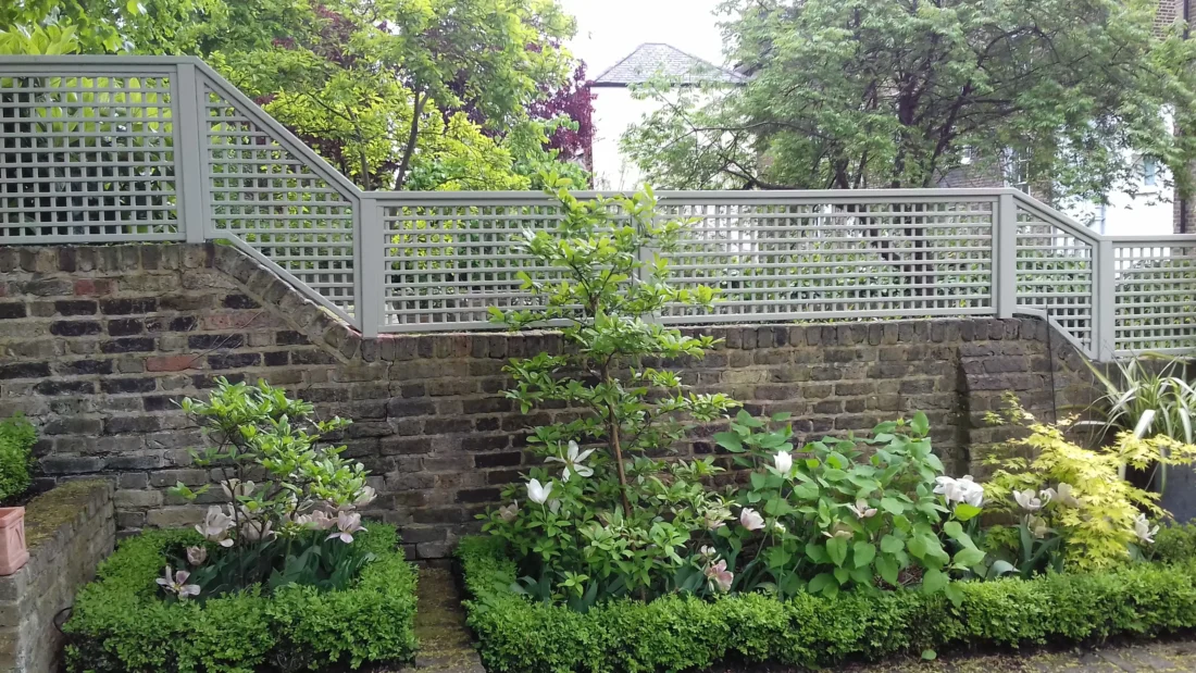 Painted Square Trellis Panels fitted atop a wall using Studded Fence Posts