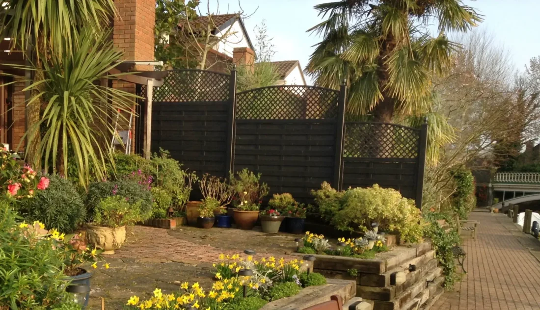 Painted Solid Fence Panels with Diagonal Trellis Topper Panels installed above