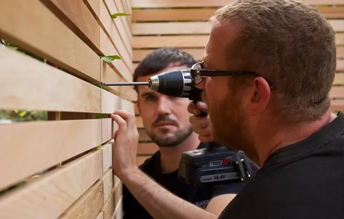 Installing slatted fence panel